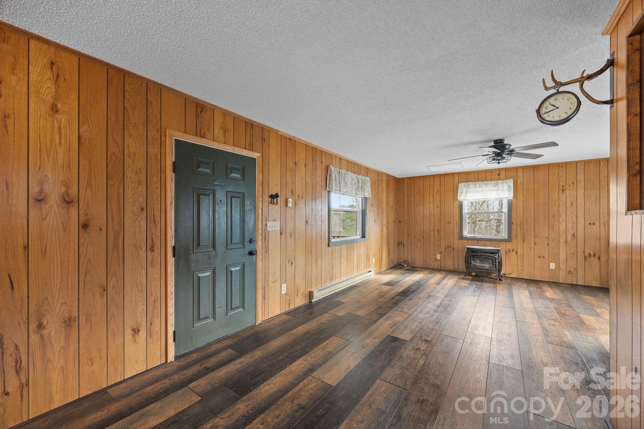 1169 Rickman Creek Road Franklin, NC 28734 - Photo 11 of 43 a view of an empty room with wooden floor and windows