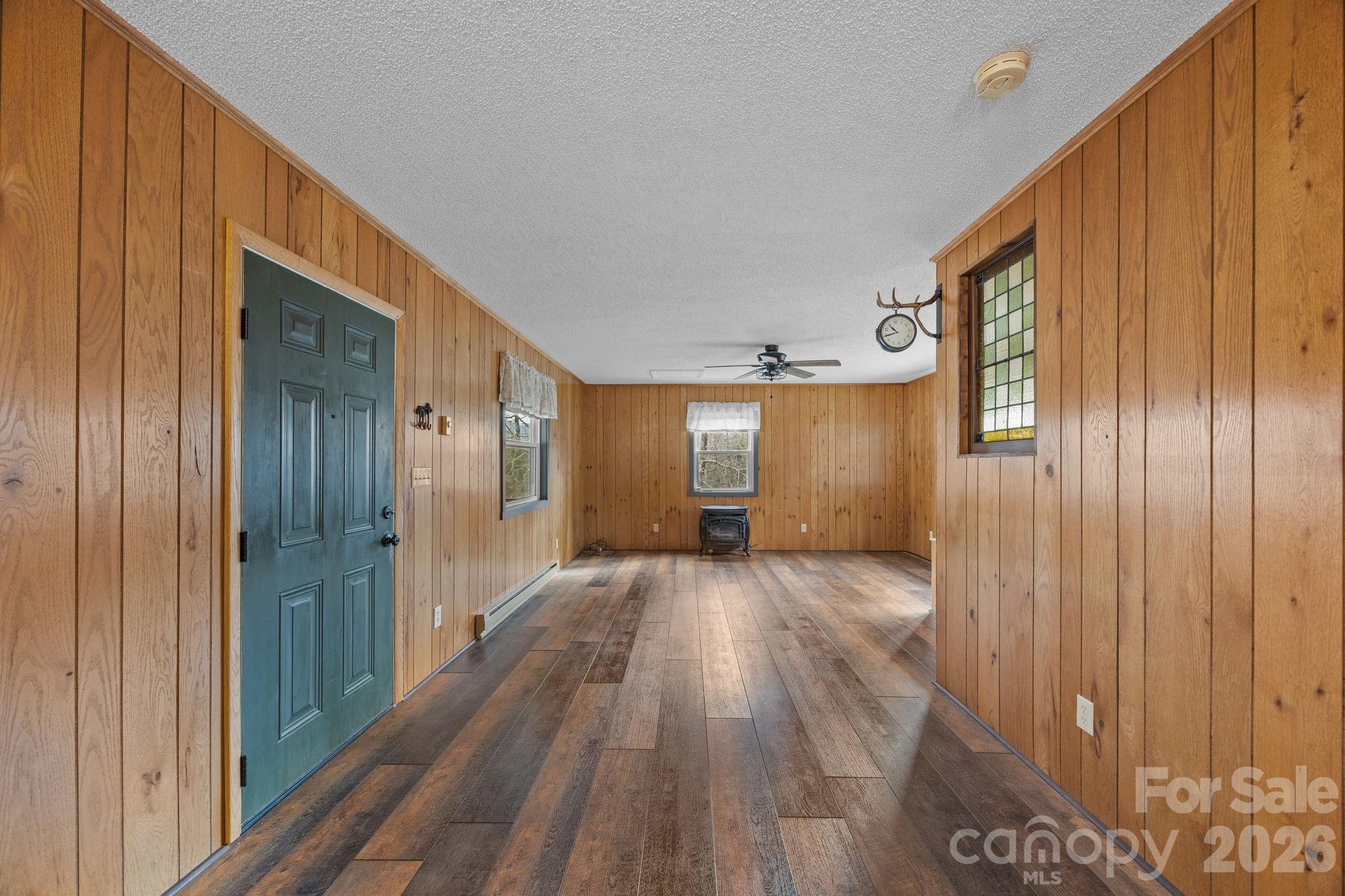 1169 Rickman Creek Road Franklin, NC 28734 - Photo 12 of 43 a view of a hallway with wooden floor and staircase