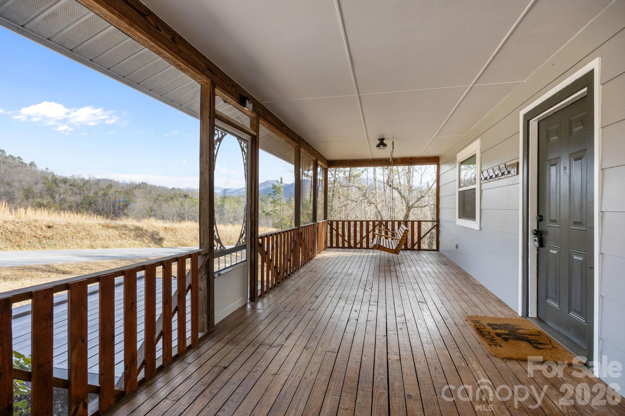1169 Rickman Creek Road Franklin, NC 28734 - Photo 14 of 43 a view of a balcony with wooden floor