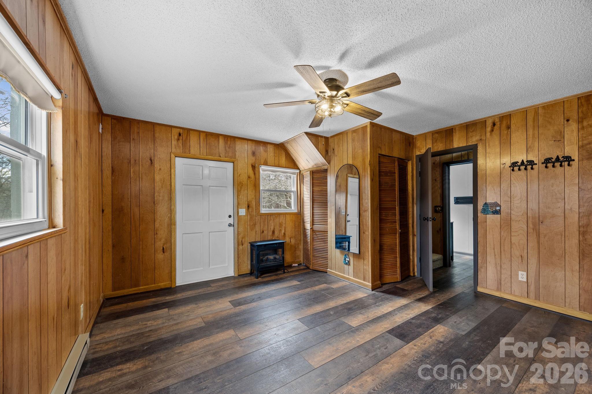 1169 Rickman Creek Road Franklin, NC 28734 - Photo 21 of 43 a view of an empty room with a window and wooden floor