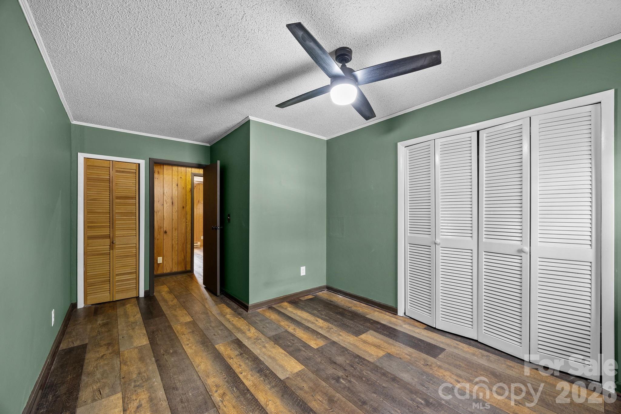 1169 Rickman Creek Road Franklin, NC 28734 - Photo 23 of 43 an empty room with closet and windows