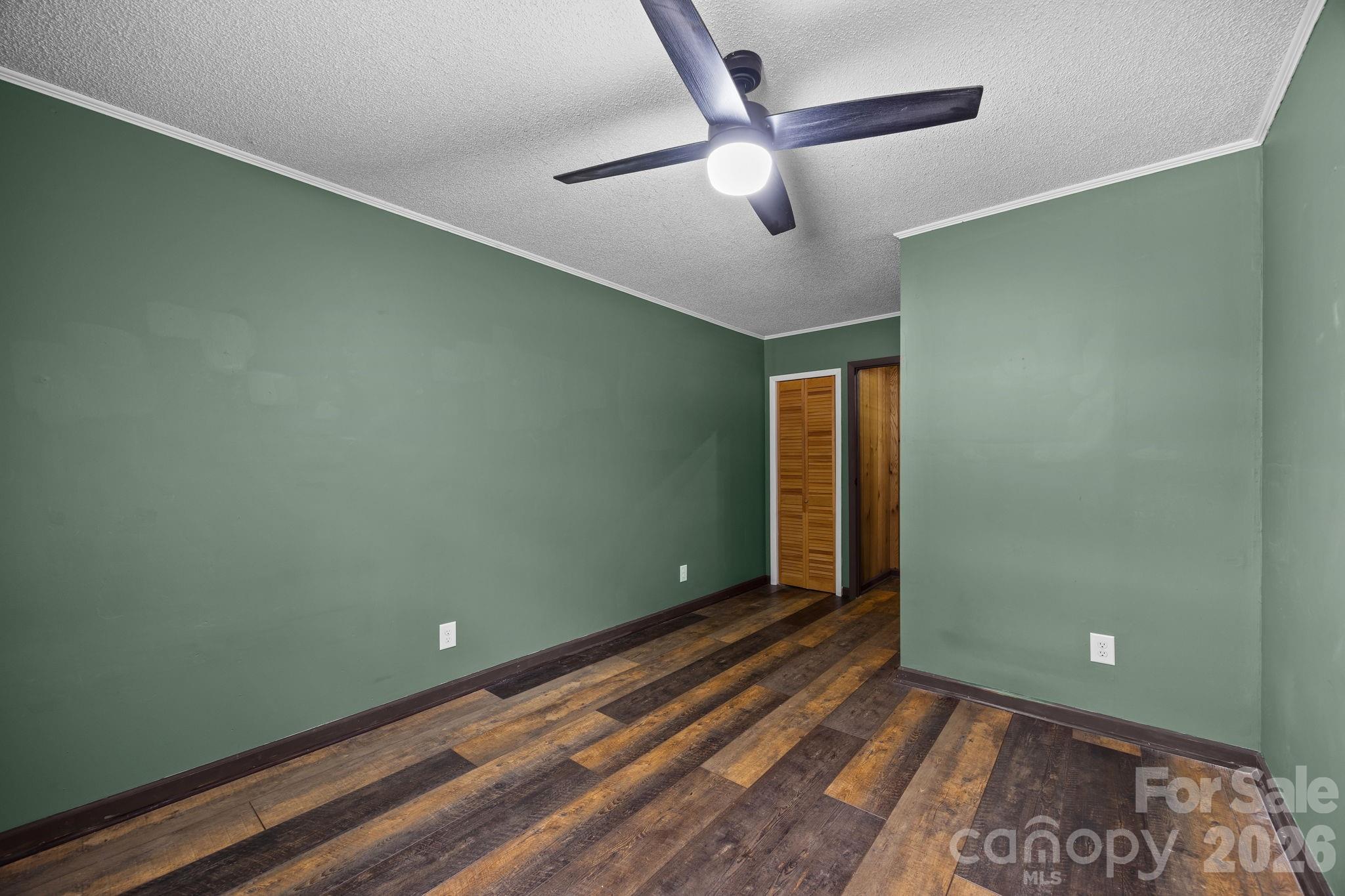 1169 Rickman Creek Road Franklin, NC 28734 - Photo 26 of 43 a view of a room with a ceiling fan and wooden floor