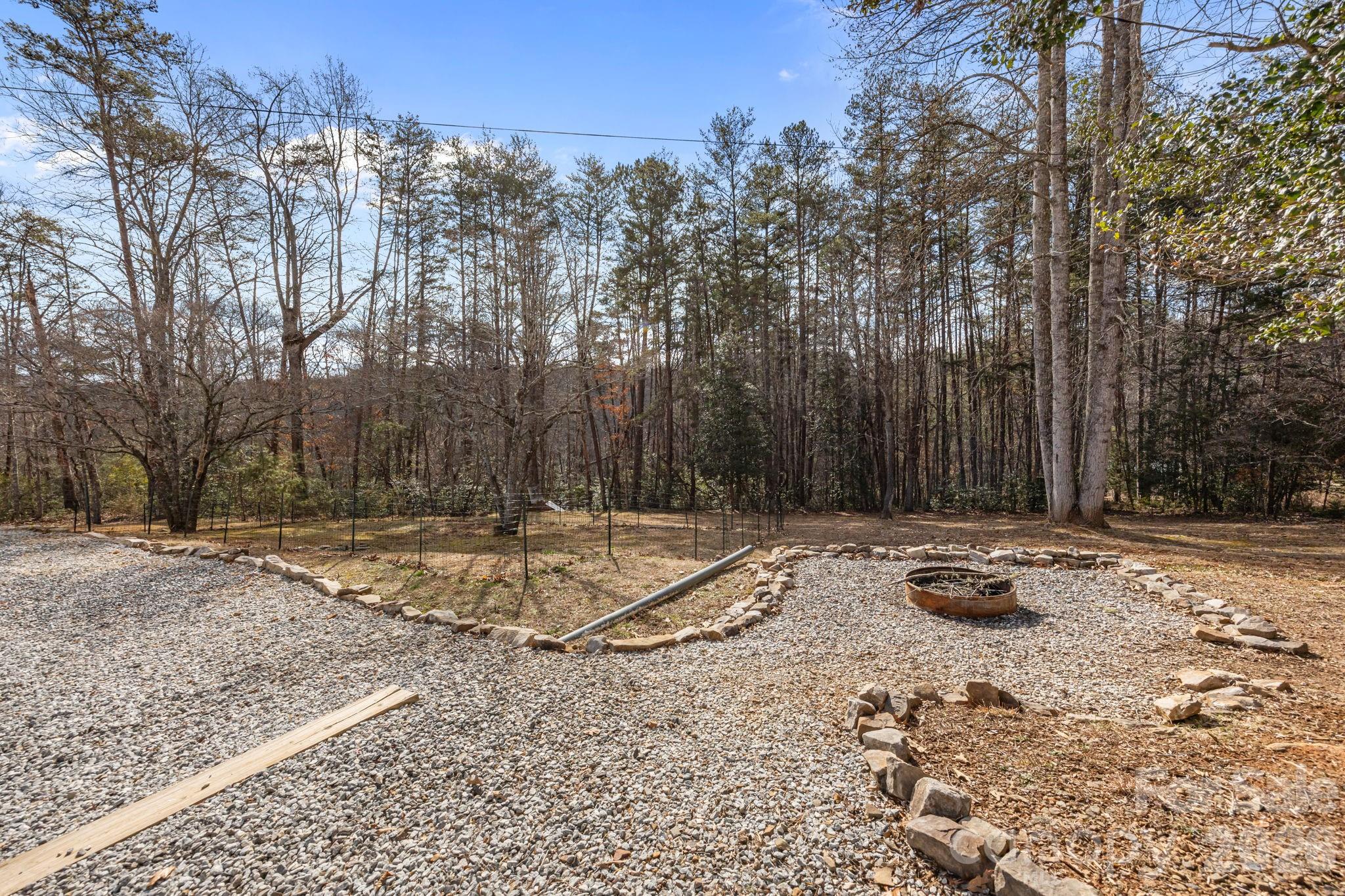 1169 Rickman Creek Road Franklin, NC 28734 - Photo 29 of 43 a backyard of a house with trees