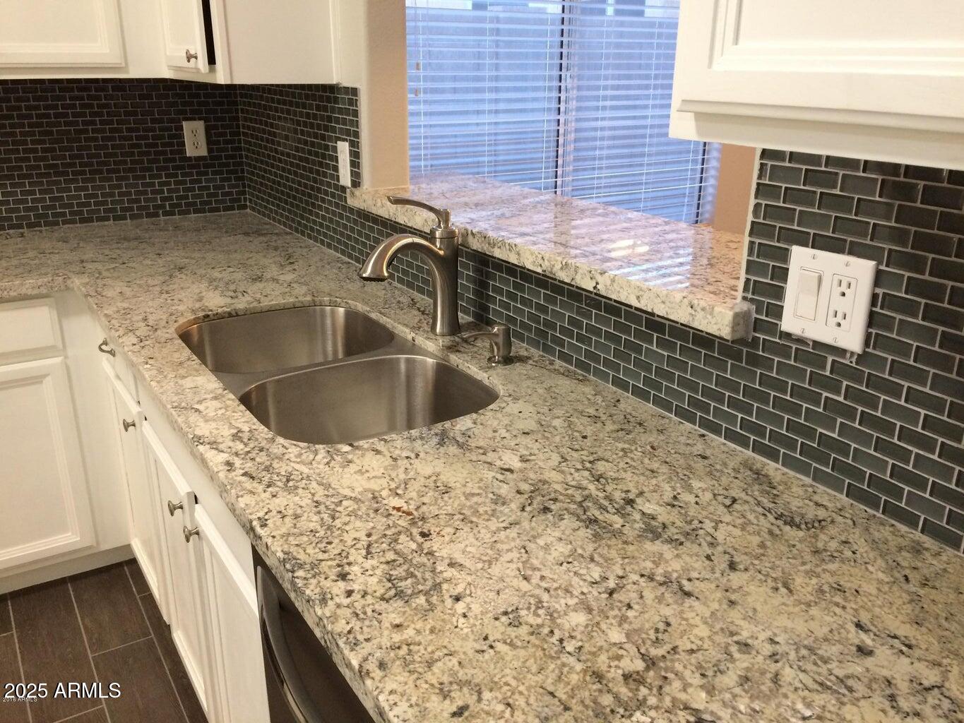 2240 East Aire Libre Avenue Phoenix, AZ 85022 - Photo 3 of 18 a kitchen with a sink and a stove