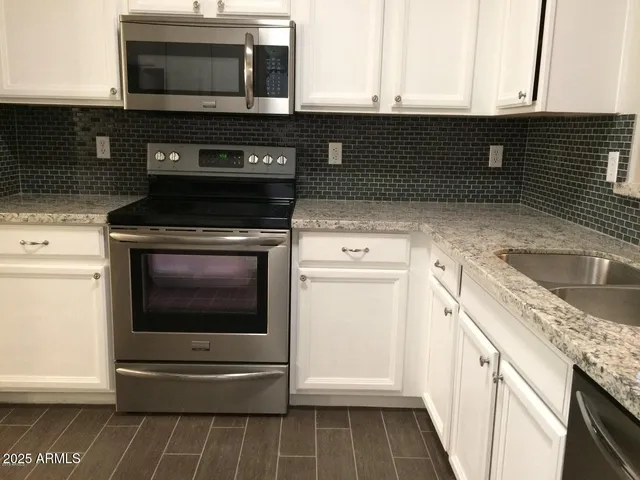 a kitchen with a stove and a microwave