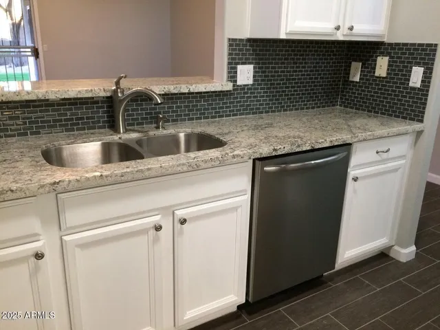 a kitchen with a sink and cabinets