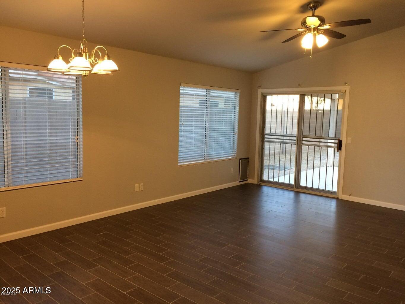 2240 East Aire Libre Avenue Phoenix, AZ 85022 - Photo 9 of 18 a view of an empty room with wooden floor and a window