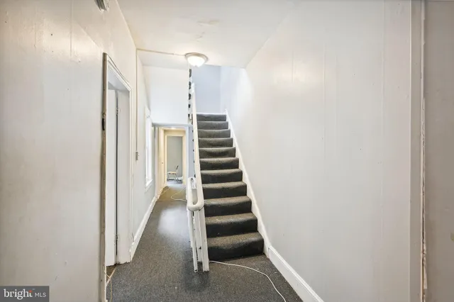 a bathroom with a toilet sink vanity and shower