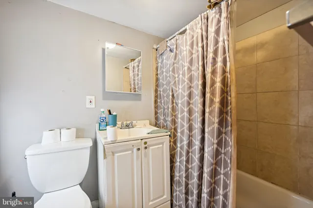 a bedroom with bed and a flat screen tv