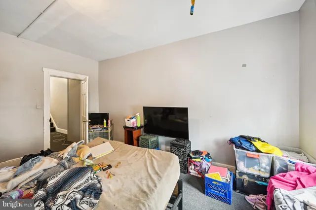 a bedroom with bed and a window