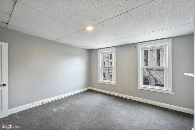 an empty room with a bench and closet