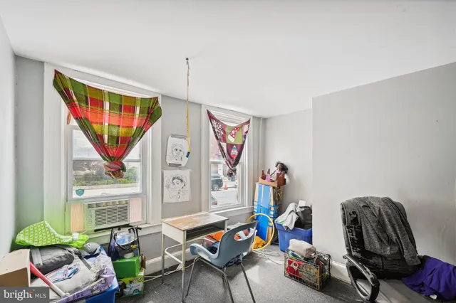 a living room with furniture a window and a flat screen tv