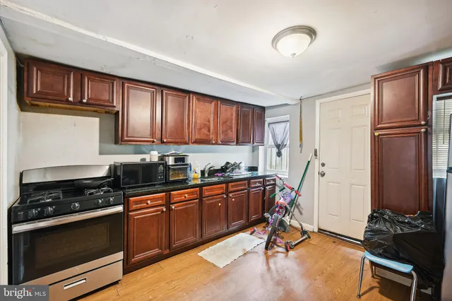 a kitchen with stainless steel appliances granite countertop a stove a sink dishwasher and a refrigerator