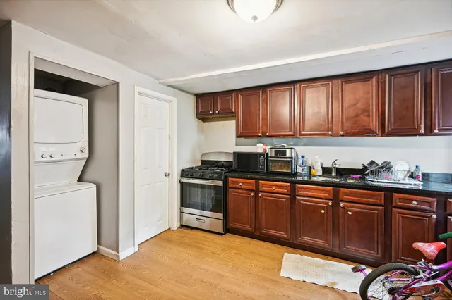 a kitchen with stainless steel appliances granite countertop a refrigerator and a stove top oven