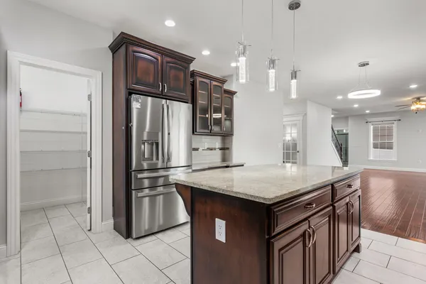 a kitchen with kitchen island a sink stove and refrigerator