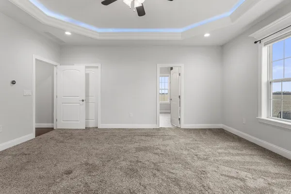 an empty room with windows and closet