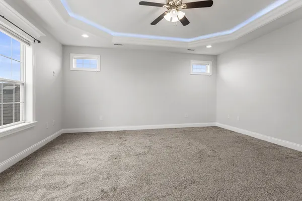 an empty room with a empty space and windows