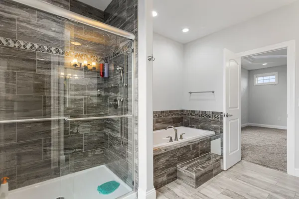 a bathroom with a tub and a shower