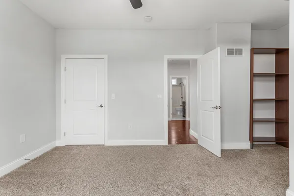 an empty room with windows and closet