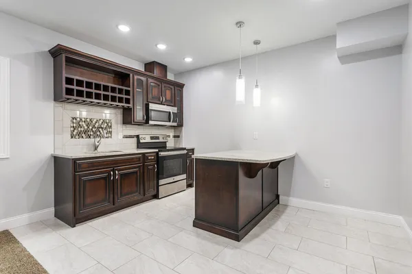 a kitchen with stainless steel appliances granite countertop a sink and a stove