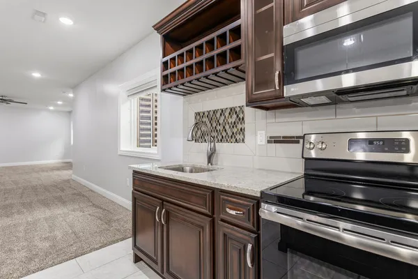 a bathroom with a granite countertop sink a toilet and shower