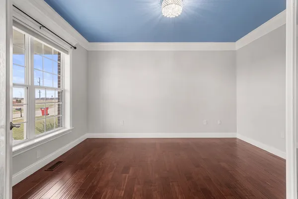 a view of wooden floor and windows in a room