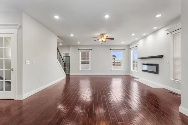 a view of empty room with wooden floor and fireplace