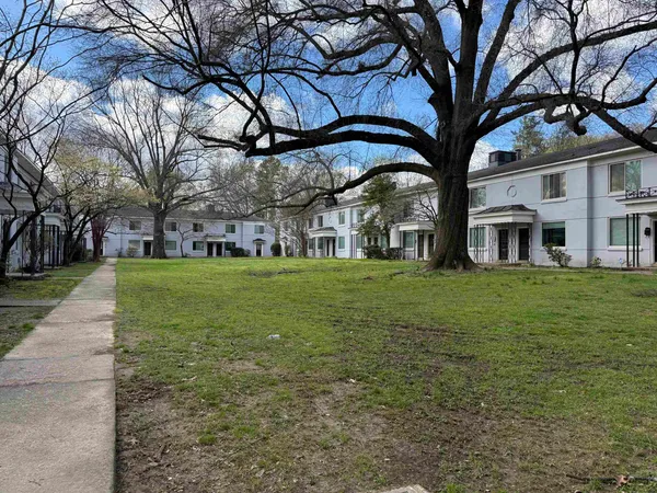 a view of a building with a yard