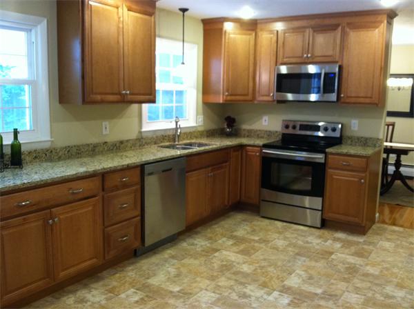 10 Colonial Road Sutton, MA 01590 - Photo 2 of 13 a kitchen with stainless steel appliances granite countertop a stove a sink and a microwave