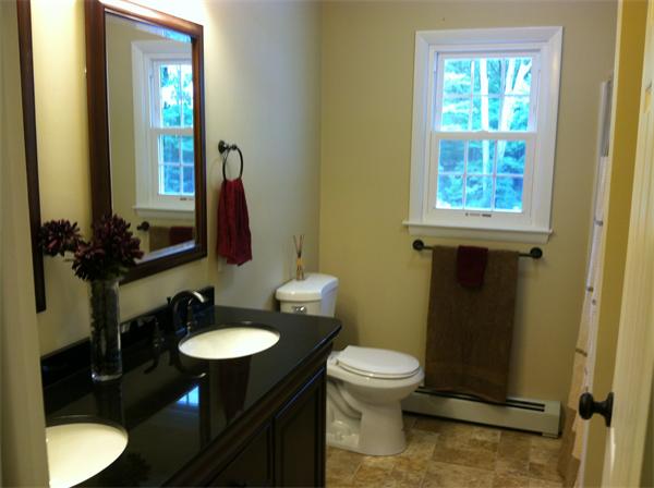 10 Colonial Road Sutton, MA 01590 - Photo 5 of 13 a bathroom with a toilet sink and mirror