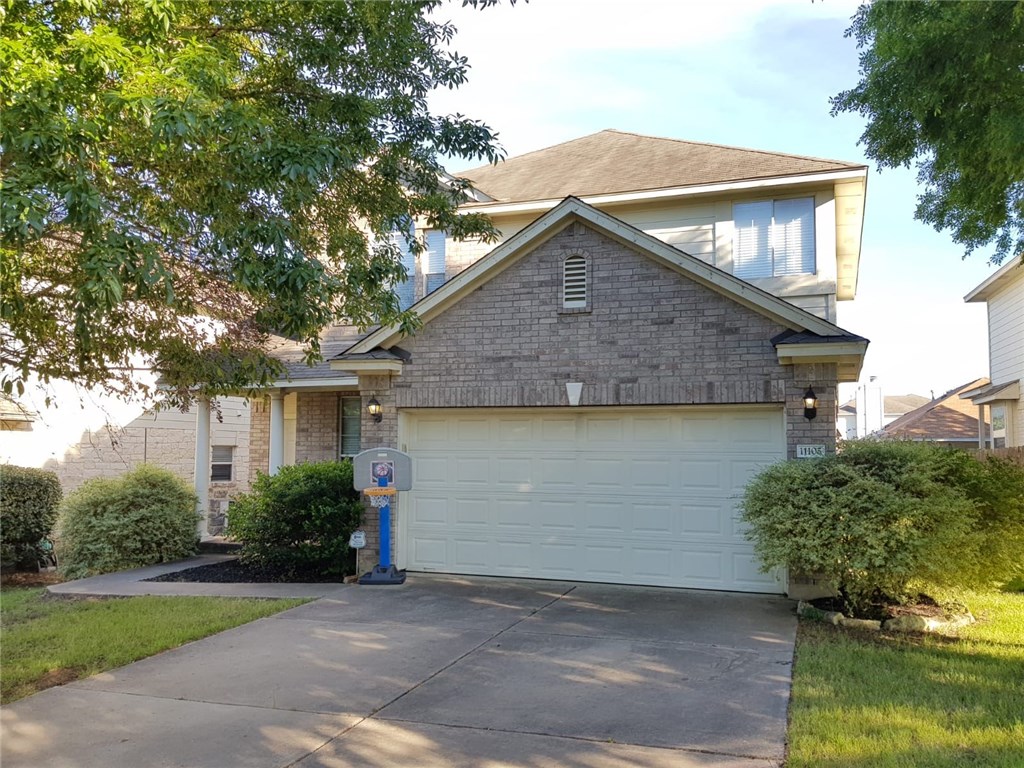 a front view of house with yard and trees around