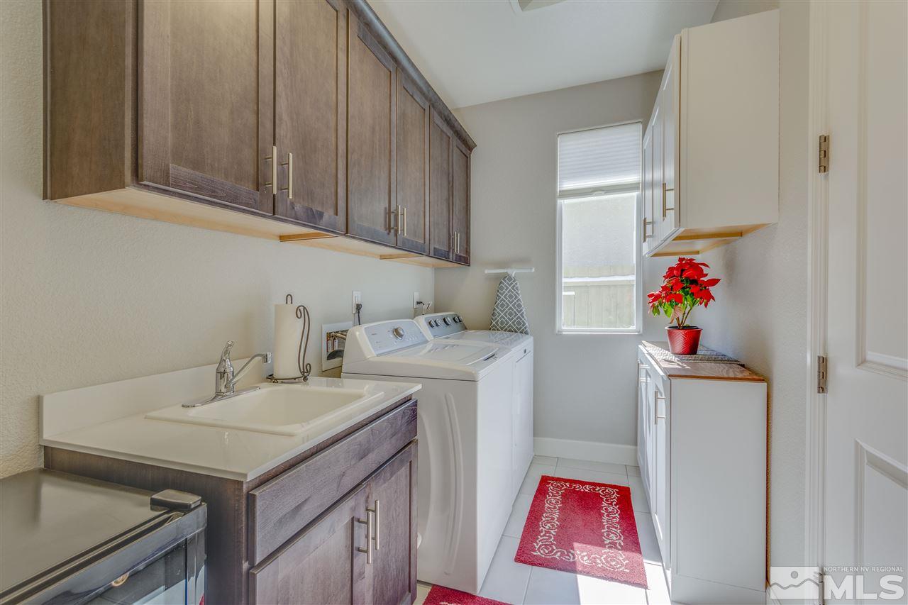 9830 Shadowless Trail Reno, NV 89521 - Photo 12 of 24 a utility room with sink dryer and washer