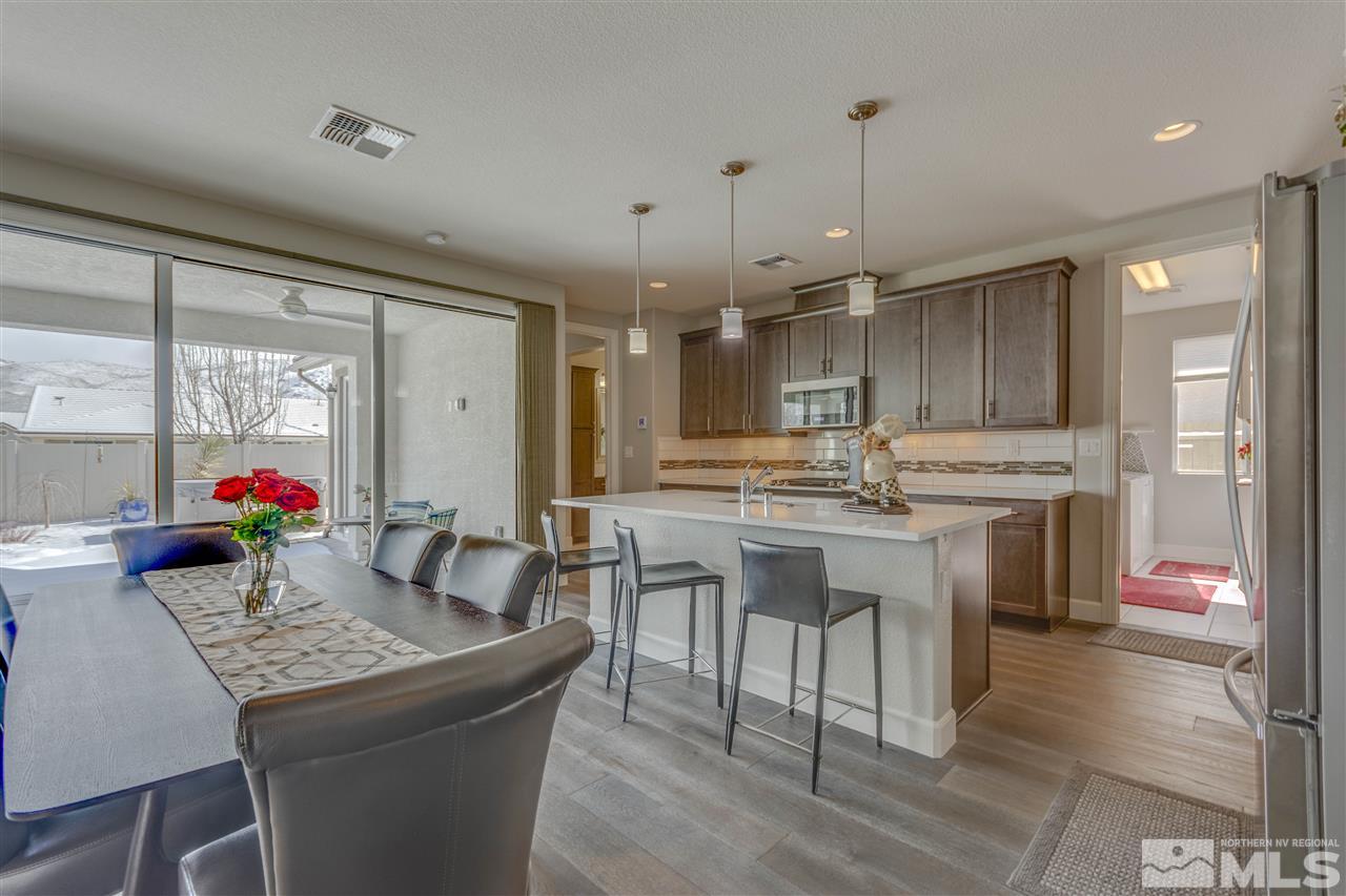 9830 Shadowless Trail Reno, NV 89521 - Photo 9 of 24 a kitchen that has a lot of white cabinets and stainless steel appliances