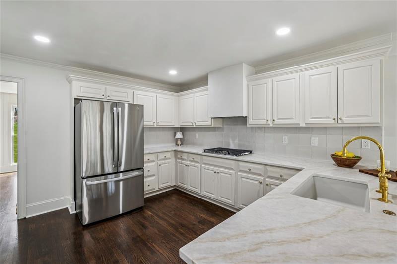 105 Inverness Approach Roswell, GA 30075 - Photo 22 of 51 a kitchen with stainless steel appliances granite countertop a refrigerator sink and stove