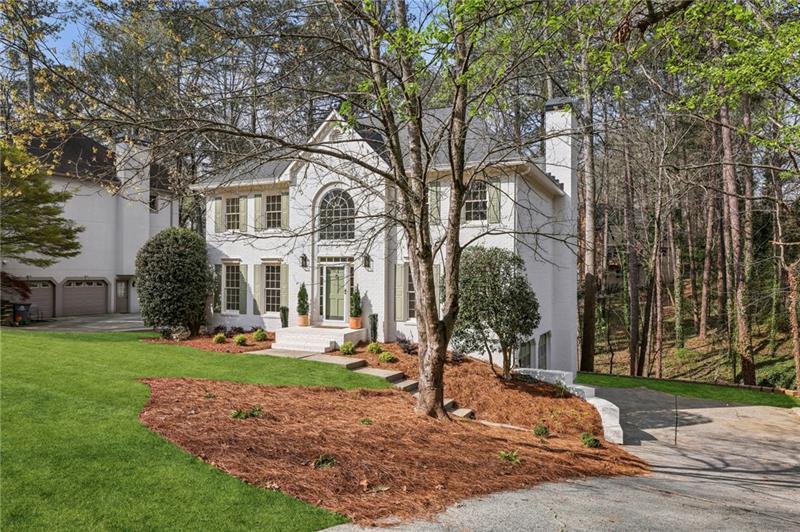 105 Inverness Approach Roswell, GA 30075 - Photo 4 of 51 a front view of a house with garden