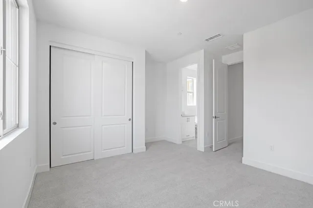 a view of an empty room and closet area