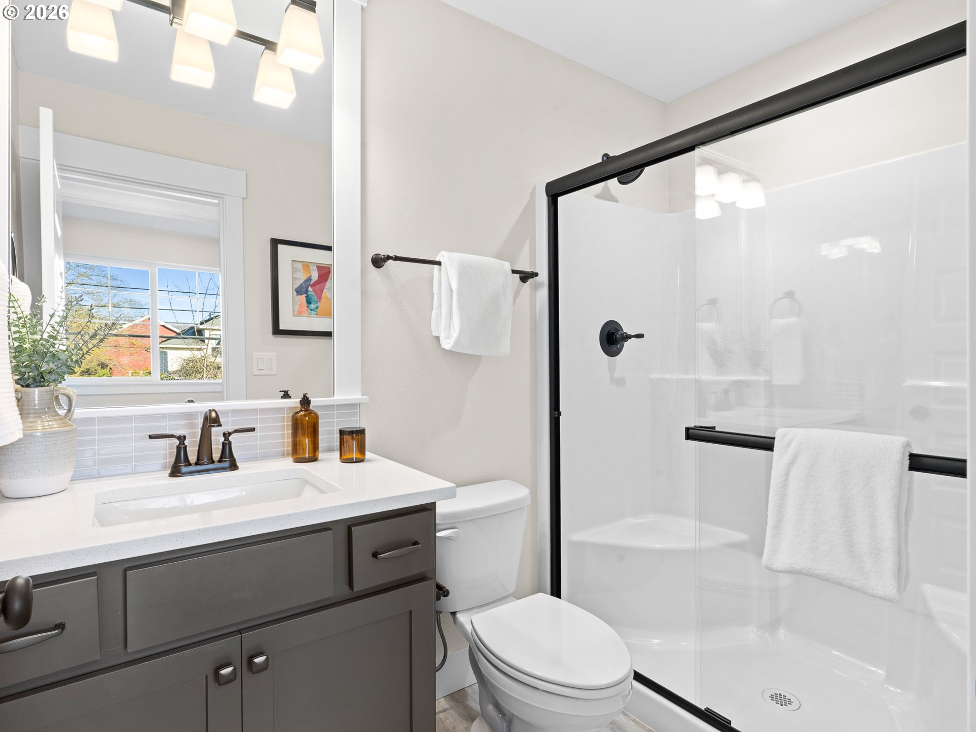 7460 North Polk Avenue Portland, OR 97203 - Photo 12 of 25 a bathroom with a sink a mirror a toilet and shower