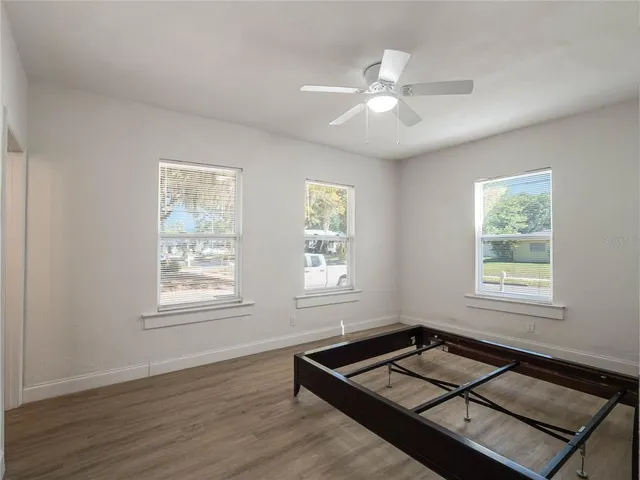 a living room with hardwood floor and window