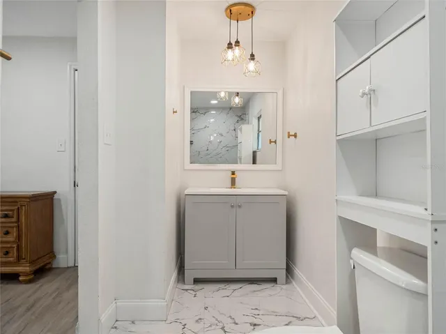 a spacious bathroom with a sink and a mirror