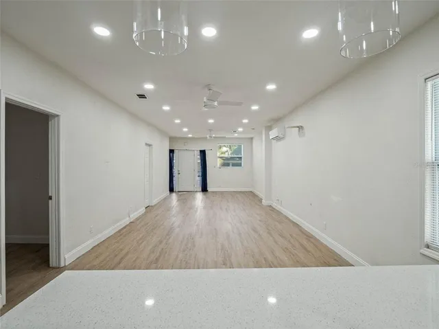 a view of empty room with wooden floor
