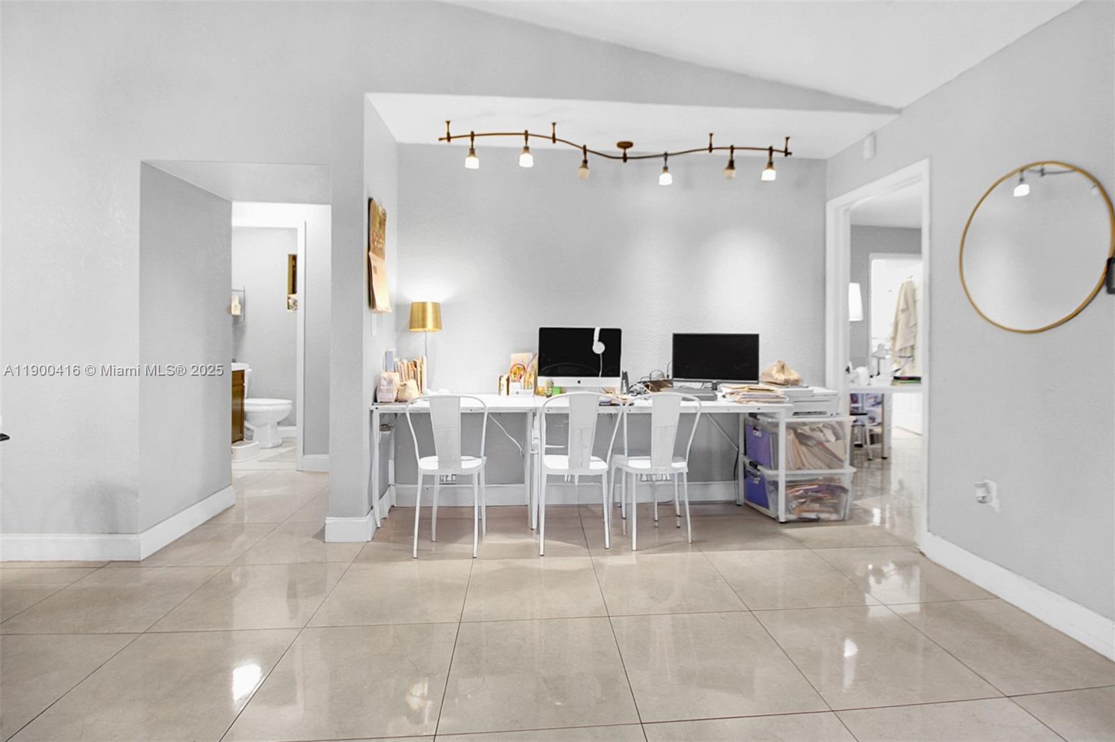 14880 Southwest 56th Terrace Miami, FL 33193 - Photo 17 of 35 a view of a livingroom with furniture a fireplace and chandelier