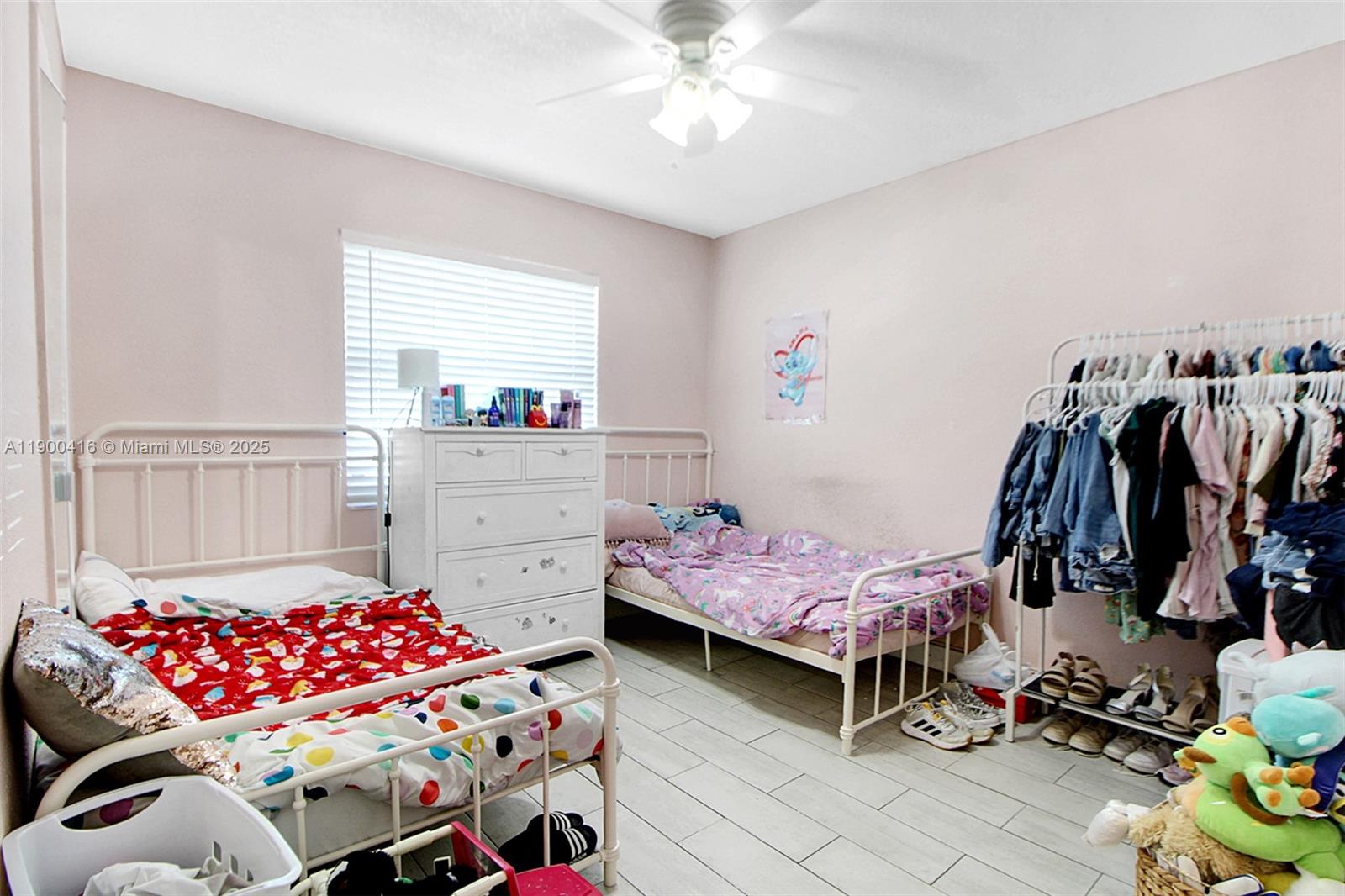 14880 Southwest 56th Terrace Miami, FL 33193 - Photo 21 of 35 a bedroom with furniture and a window