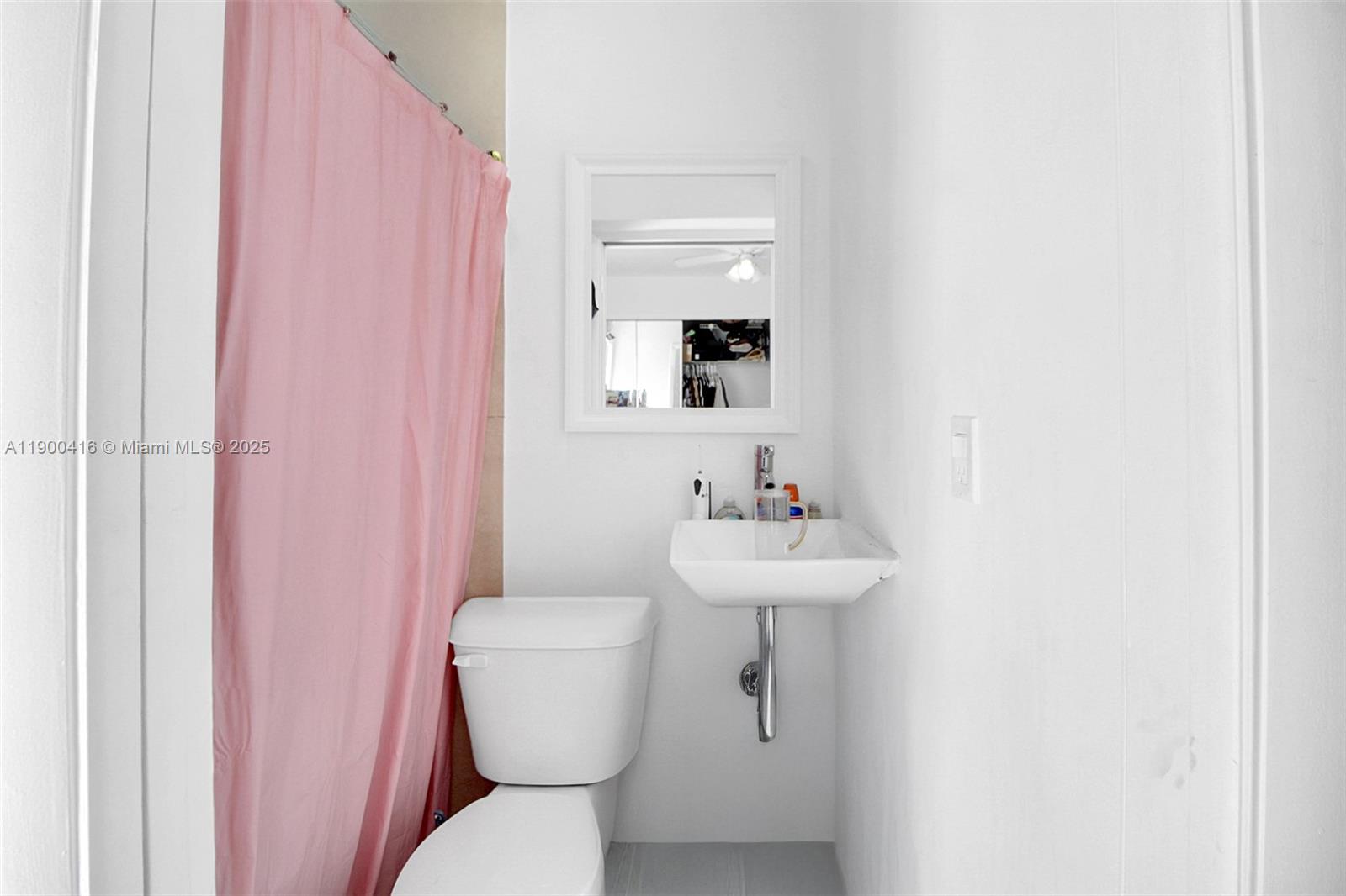 14880 Southwest 56th Terrace Miami, FL 33193 - Photo 9 of 35 a bathroom with a toilet sink and mirror