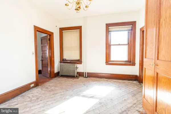 a view of a bedroom with closet and mirror