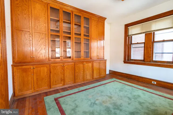 view of an empty room with wooden floor and a window