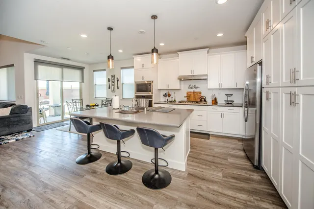 a kitchen with granite countertop white cabinets and white appliances