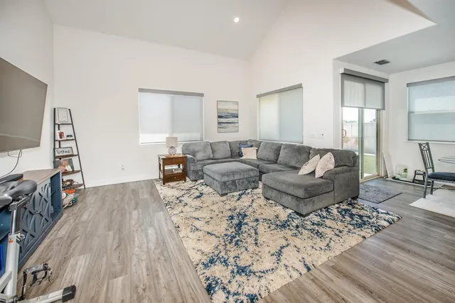 a living room with furniture and a wooden floor