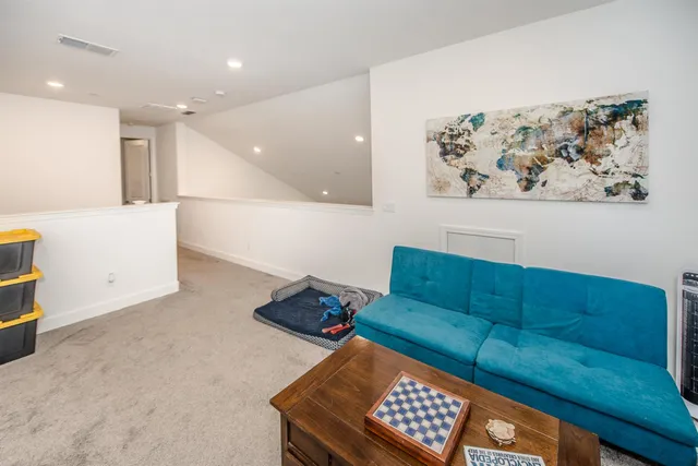 a view of backyard with outdoor seating and plants