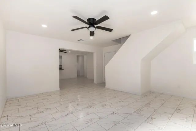 a view of a livingroom with a ceiling fan and window