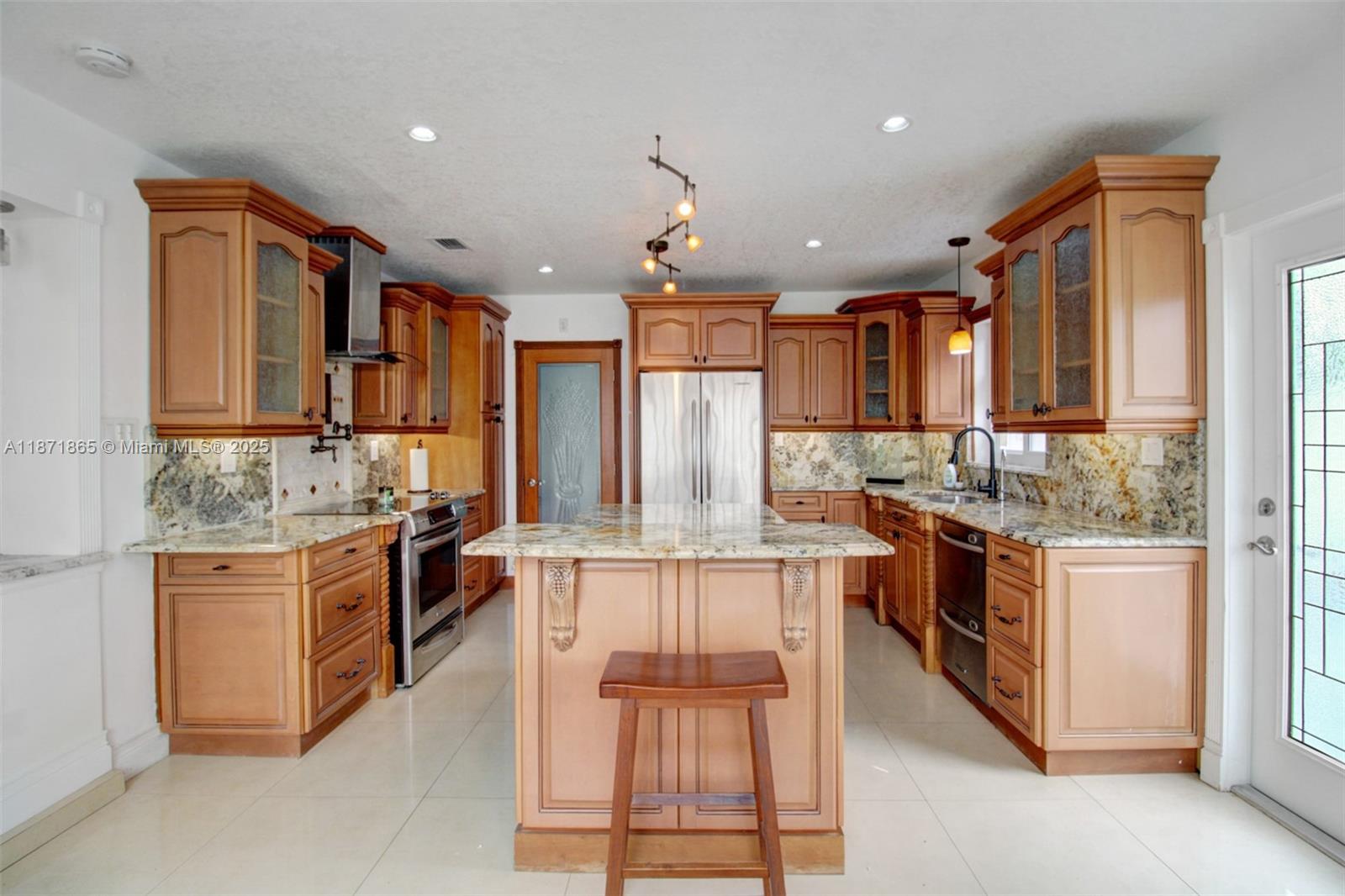 9930 Southwest 48th Street Miami, FL 33165 - Photo 11 of 29 a kitchen with stainless steel appliances granite countertop a stove and cabinets